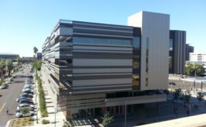 A large building with a parking lot in the background, designed and constructed by MKB Construction Services.