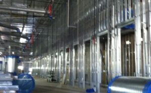 MKB Construction Services transformed a spacious room, incorporating robust steel studs and sturdy pipes into its design.